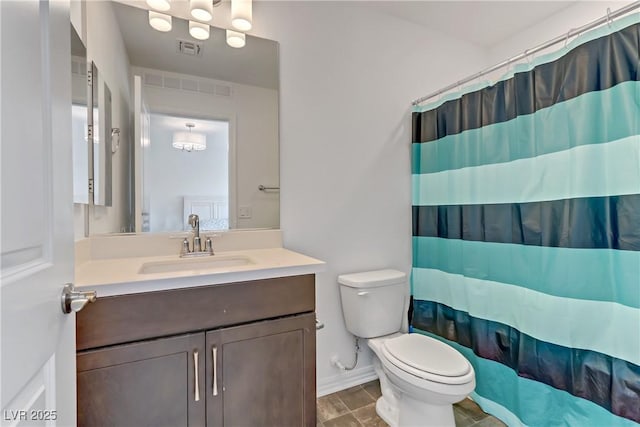 bathroom with curtained shower, vanity, and toilet