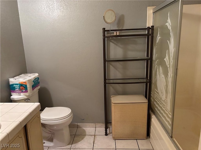 bathroom with tile patterned flooring, vanity, and toilet