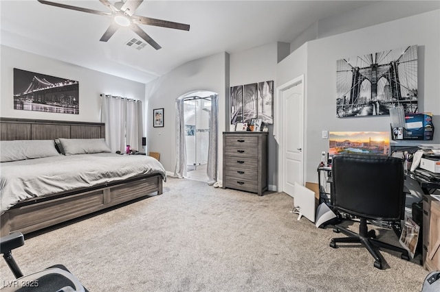 carpeted bedroom with ceiling fan and vaulted ceiling