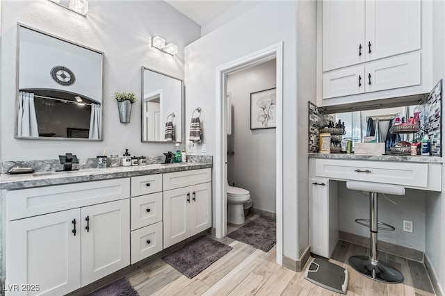 bathroom featuring hardwood / wood-style flooring, vanity, and toilet