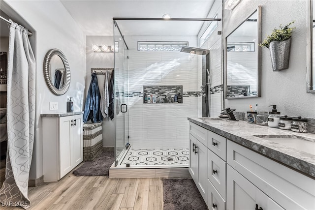 bathroom featuring vanity and a shower with shower door