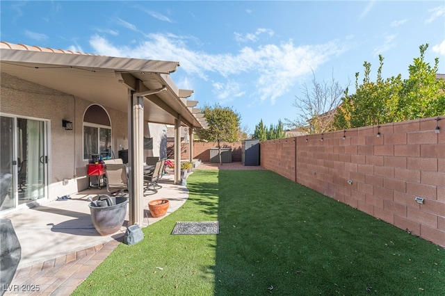 view of yard featuring a shed and a patio