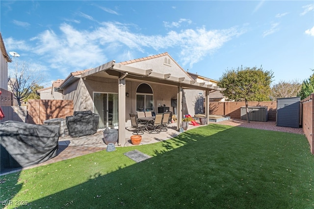 back of property with a patio, a shed, and a lawn