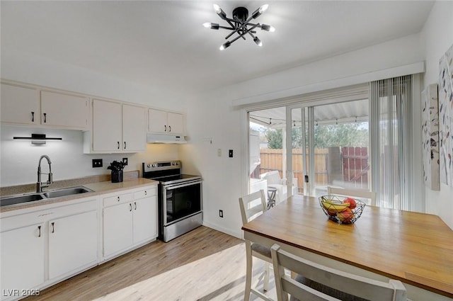 kitchen featuring an inviting chandelier, electric range, white cabinets, light hardwood / wood-style flooring, and sink