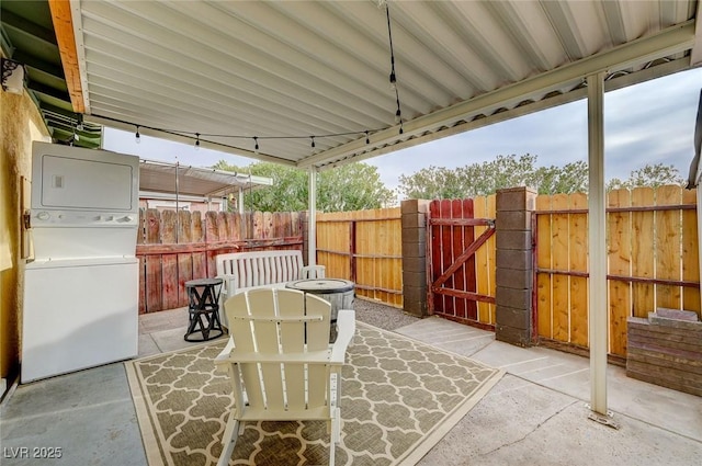 view of patio featuring stacked washing maching and dryer