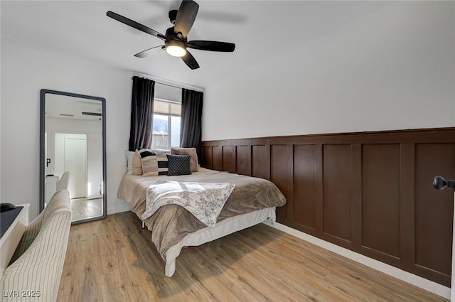 bedroom with ceiling fan and light hardwood / wood-style floors