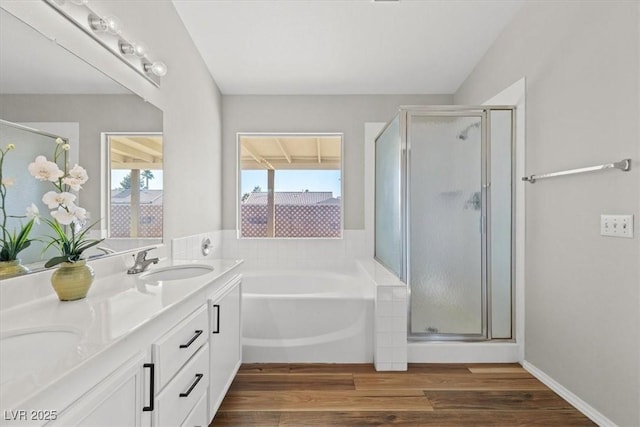 bathroom with vanity, wood-type flooring, and shower with separate bathtub