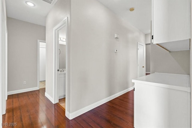 hallway featuring dark hardwood / wood-style flooring