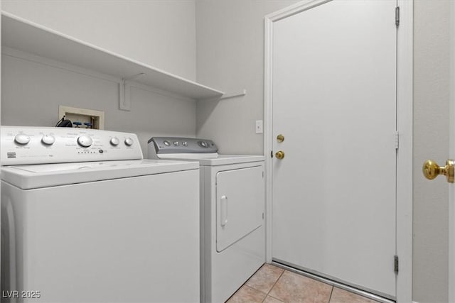 laundry area featuring light tile patterned flooring and washing machine and dryer