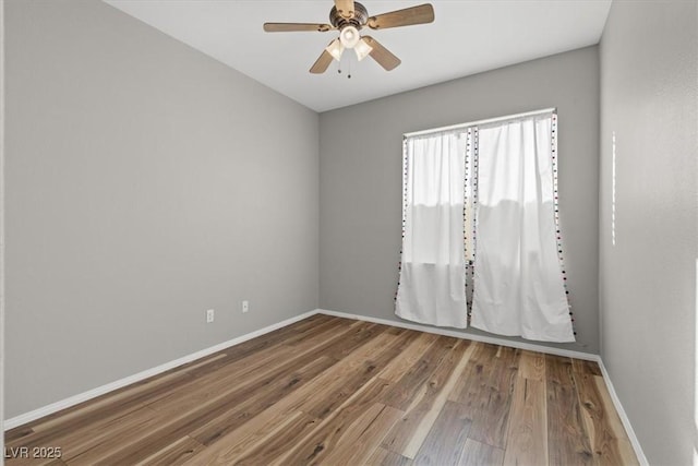 spare room with hardwood / wood-style floors and ceiling fan