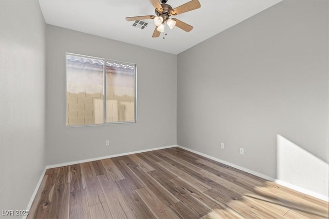 unfurnished room with ceiling fan and hardwood / wood-style floors