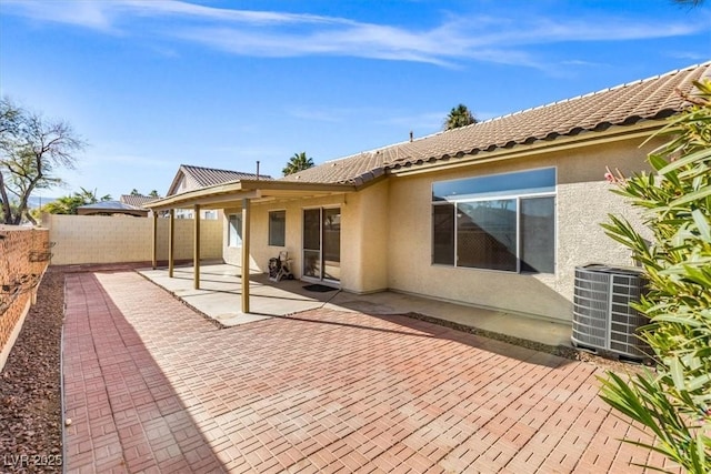 rear view of property featuring a patio area and central AC