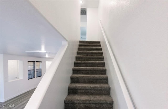 stairs featuring wood-type flooring