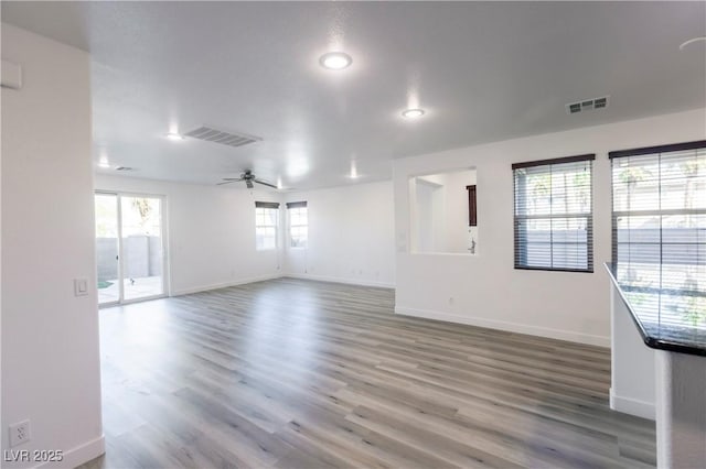 spare room with hardwood / wood-style flooring and ceiling fan