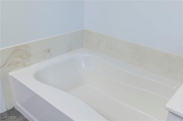 bathroom featuring tile patterned flooring and a bathtub