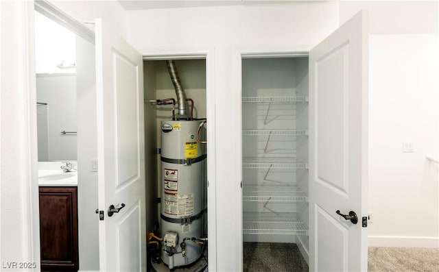 utility room featuring secured water heater and sink