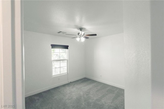 spare room featuring ceiling fan and carpet floors