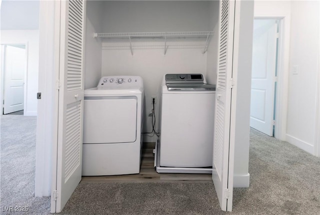 clothes washing area with washer and clothes dryer and carpet floors