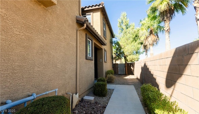 view of side of property featuring a patio area