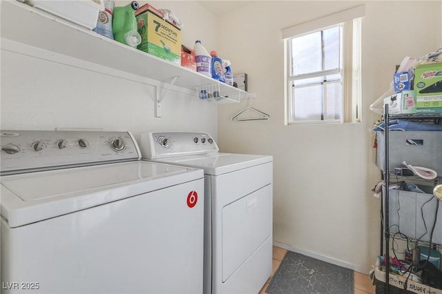 laundry room featuring washing machine and dryer and light tile patterned floors