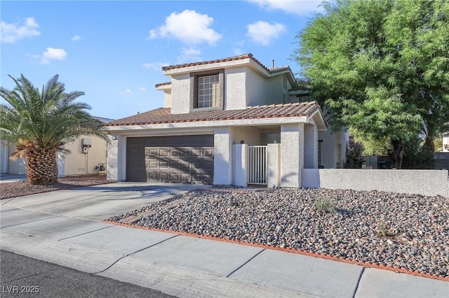 mediterranean / spanish-style home with a garage