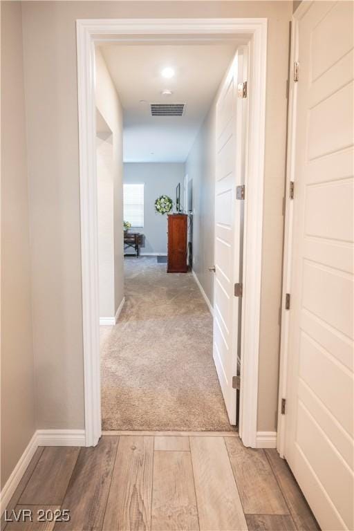 hallway with light carpet