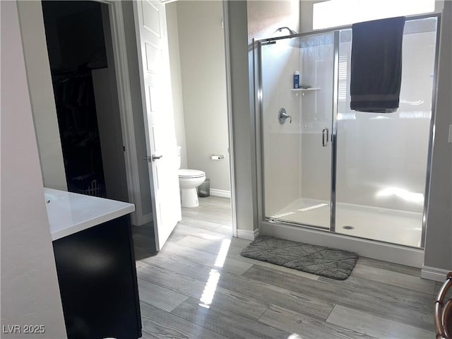 bathroom featuring vanity, toilet, and walk in shower