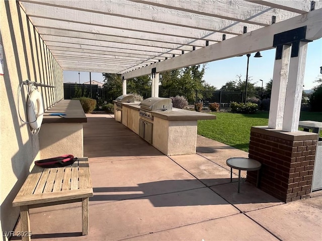 view of patio with an outdoor kitchen, area for grilling, and a pergola