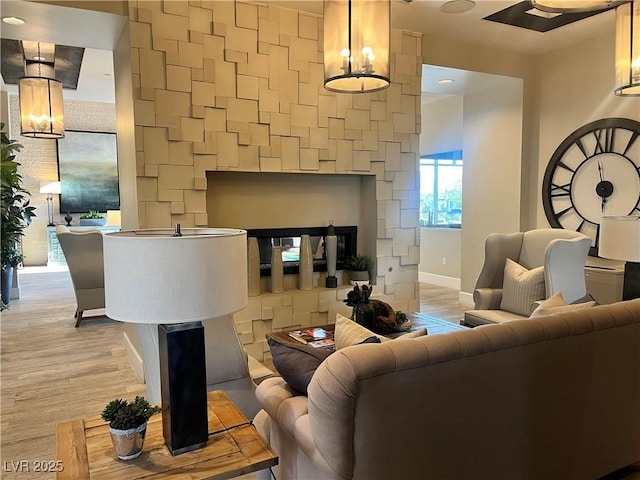 living room with a notable chandelier and light wood-type flooring