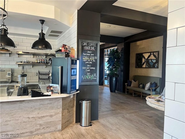 kitchen featuring stainless steel fridge, parquet floors, and tasteful backsplash