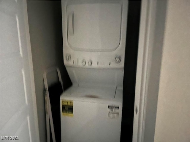 laundry room with stacked washing maching and dryer