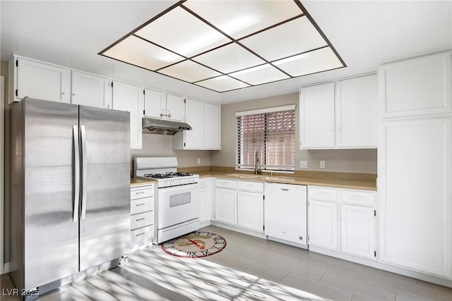 kitchen featuring white cabinets, white appliances, and sink