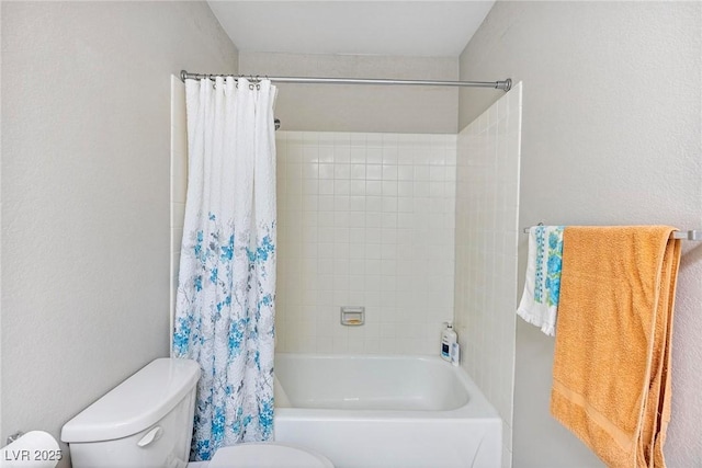 bathroom featuring toilet and shower / bath combo with shower curtain