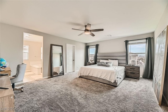 carpeted bedroom featuring connected bathroom and ceiling fan