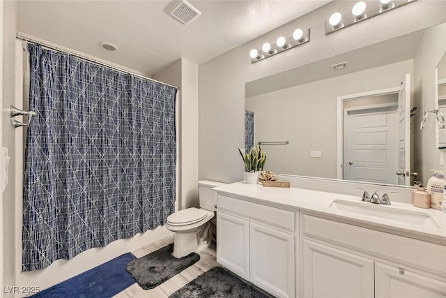 bathroom with tile patterned floors, vanity, and toilet