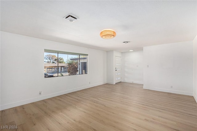 unfurnished room with light hardwood / wood-style floors