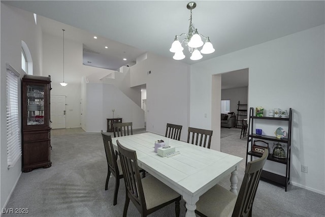 dining space featuring a chandelier and light carpet