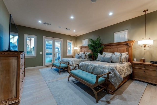 bedroom featuring access to exterior and light hardwood / wood-style flooring