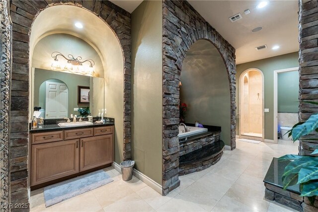 bathroom featuring vanity and a tub