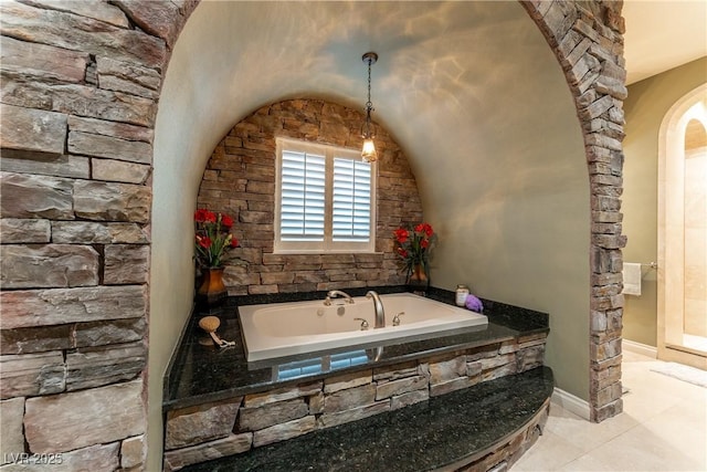 bathroom with a relaxing tiled tub