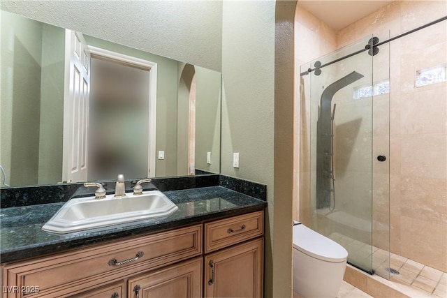 bathroom with vanity, an enclosed shower, and toilet