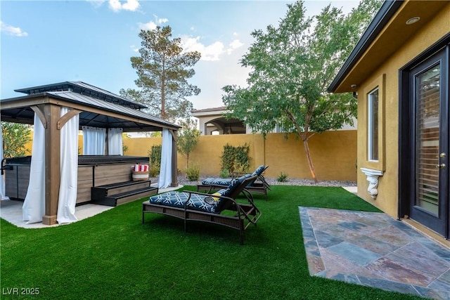 view of yard with a gazebo, a hot tub, and a patio area