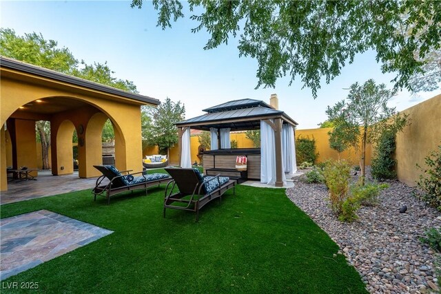 view of yard featuring a gazebo, a patio area, an outdoor hangout area, and a hot tub