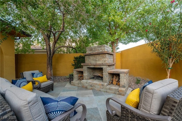 view of patio / terrace with an outdoor living space with a fireplace