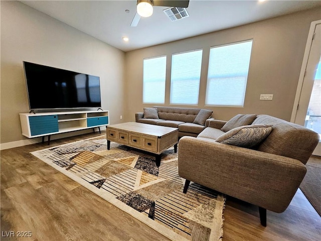 living room with hardwood / wood-style floors and ceiling fan