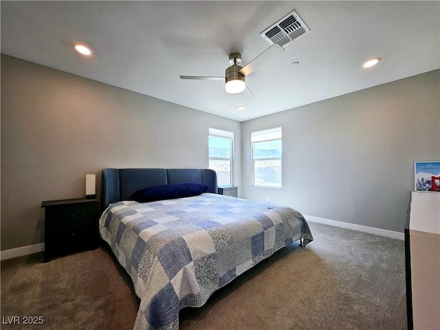 bedroom with ceiling fan and dark colored carpet