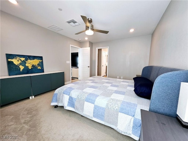 carpeted bedroom with ceiling fan and ensuite bathroom