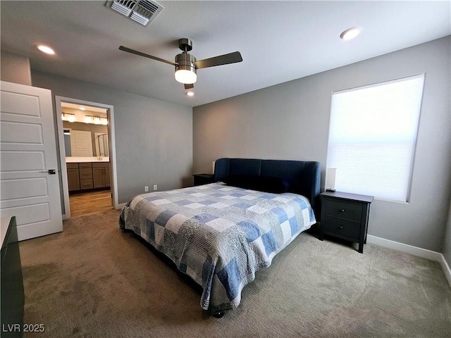 bedroom with ensuite bath, ceiling fan, and carpet floors