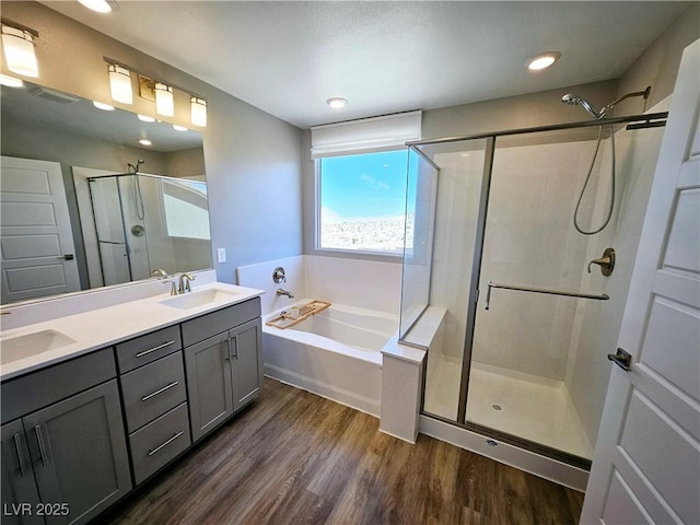 bathroom featuring hardwood / wood-style floors, vanity, and independent shower and bath