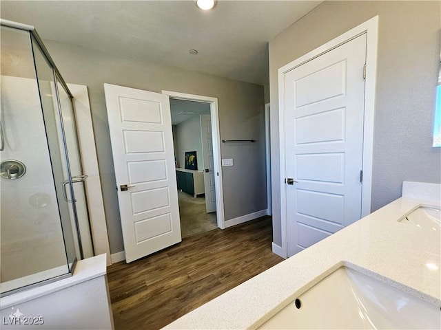 bathroom featuring hardwood / wood-style flooring, vanity, and an enclosed shower